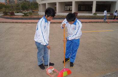 （图三）同学们正在打扫图书馆附近的校道